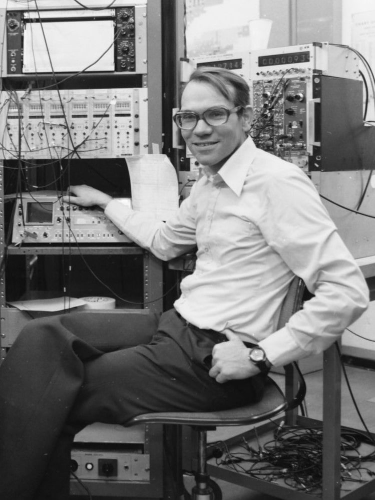 Man sitting with electronics in the background